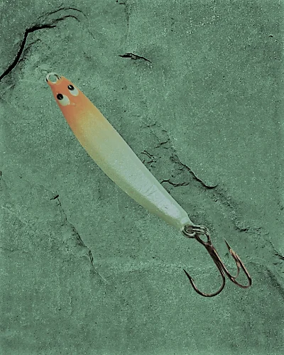  jigging spoon is metallic allure adds perplexity to the water's clarity, mimicking an injured minnow's wobbling dance.